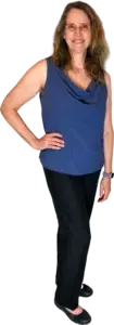 Kari wearing black trousers and a blue sleeveless top, standing and smiling